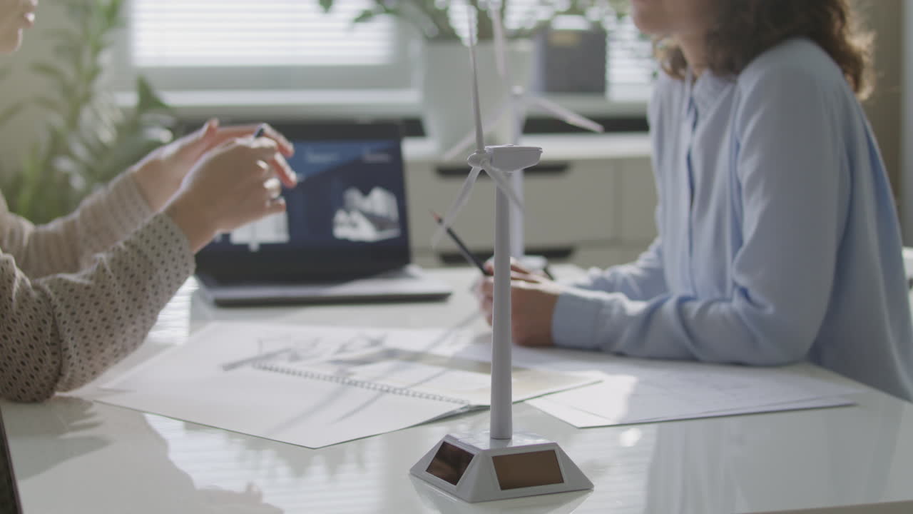 Close Up of Wind Turbine Model on Office Table during Professional Meeting