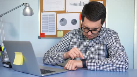 man checking time at office desk