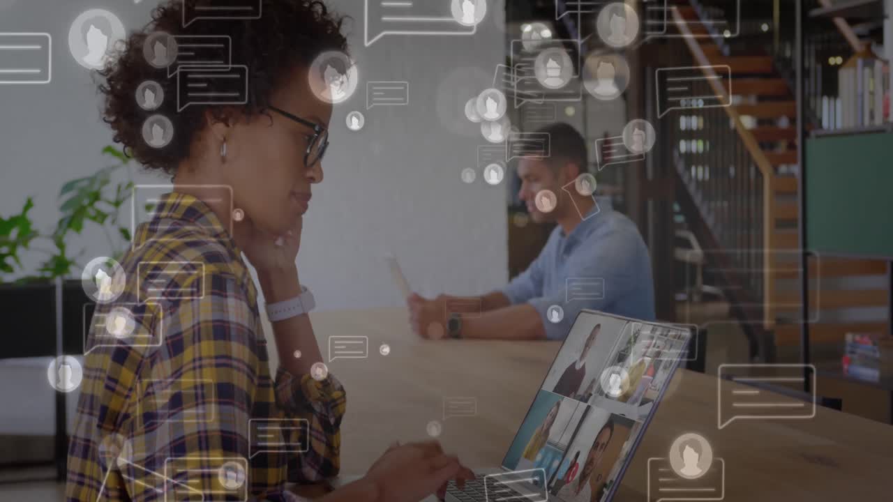 Animation of social media icons with speech bubbles over african american woman using laptop