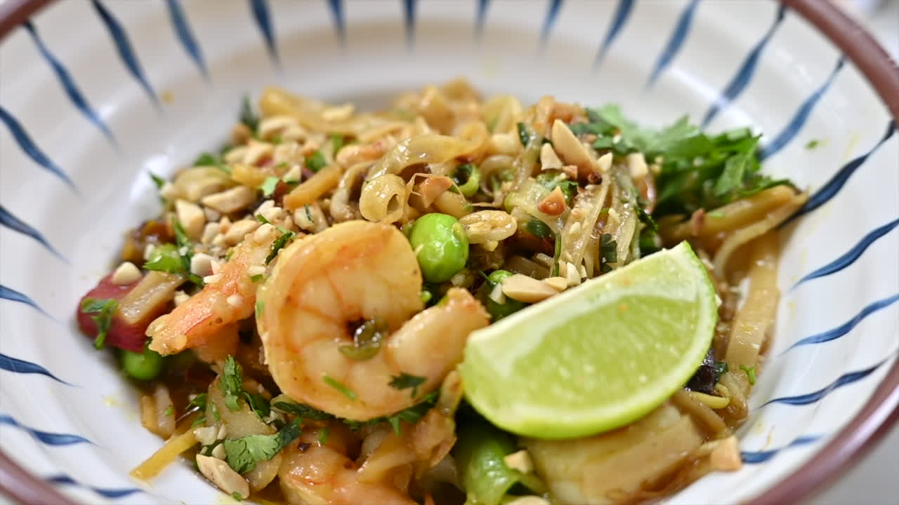 Japanese noodles with shrimps on a plate, wooden chopsticks