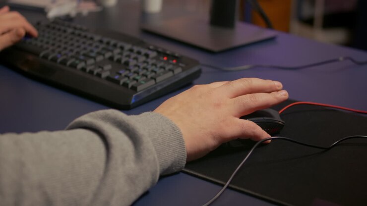 Close-up on hands of player man using professional RGB mouse