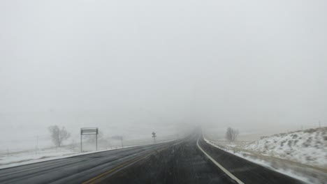 pov footage of driving in the countryside of boulder, colorado during a snowstorm