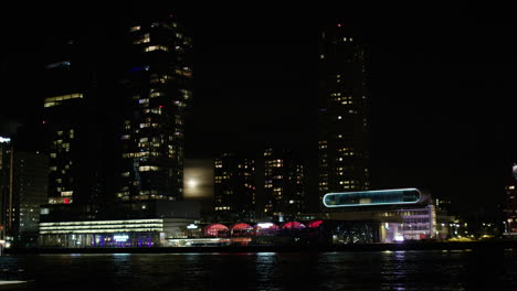 The-skyline-of-Rotterdam-during-night-time-with-a-full-moon
