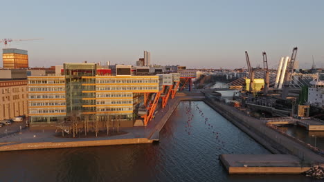 aerial tracking shot of the harbor in salmisaari, sunny evening in helsinki, finland