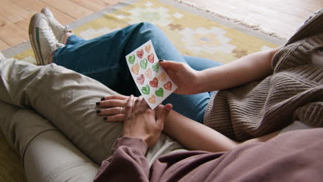 young couple sitting on the carpet