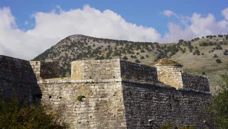 medieval castle stone walls of fortress with mountain background in mediterranean