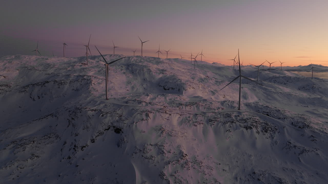 Wind turbines on snowy mountains in arctic at sunset in Norway