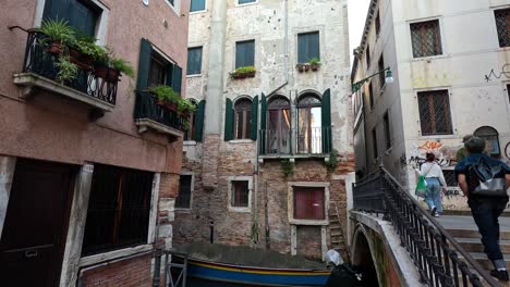 people walking over a bridge in venice