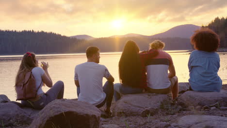 friends enjoying sunset by the lake a