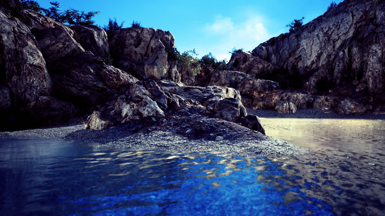 Tranquil rocky shoreline at dusk with calm blue waters reflecting light