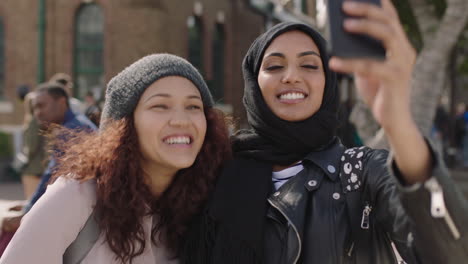 portrait-of-two-young-woman-friends-close-up-of-multi-ethnic-girlfriends-posing-making-faces-taking-selfie-photo-using-smartphone