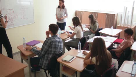 pupils on class in school doing mathematical task on chalkboard