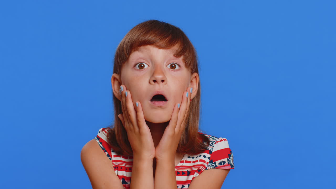 Excited child girl kid surprised shocked by sudden victory good win news celebrating wow reaction