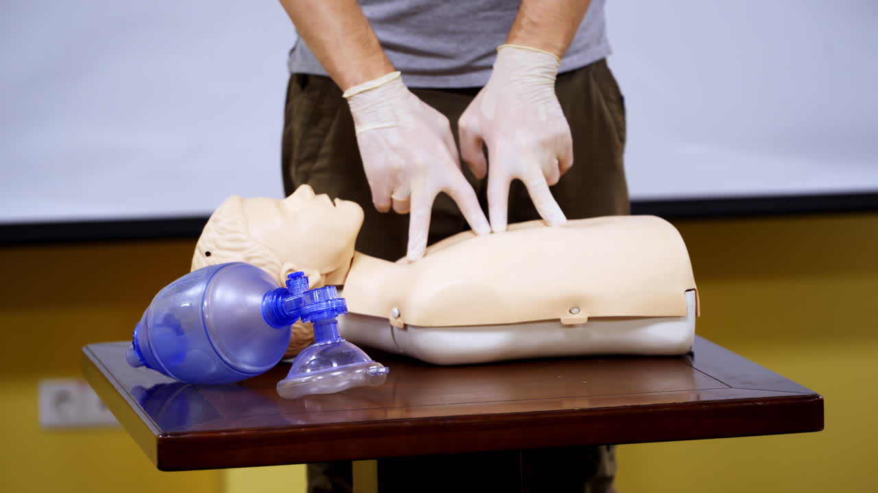 Medical male dummy lays on training table in hall. Medical equipments for first aid education. Courses for giving necessary health help.