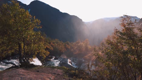 camera moving through trees, towards viewpoint, revealing beautiful river and mountains in the backgroud