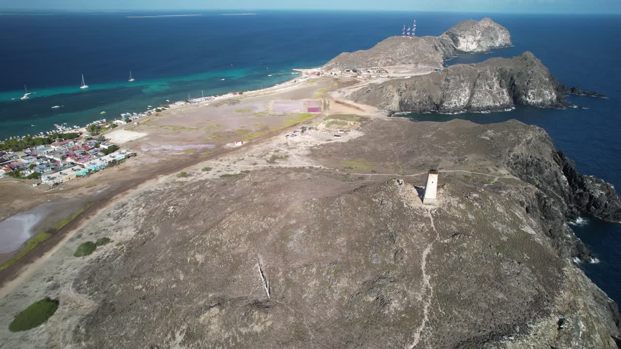 A lighthouse on a rugged coastal landscape near gran roque, venezuela, aerial view