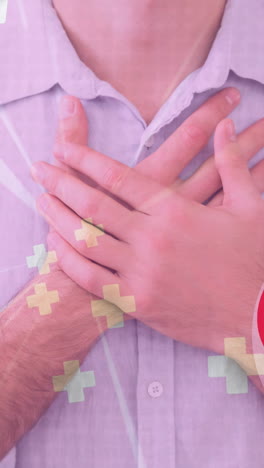 animación de corazón y cruces iconos sobre el hombre caucásico sosteniendo su pecho