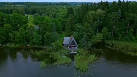 drone images of a house with a terrace on the edge of a lake
