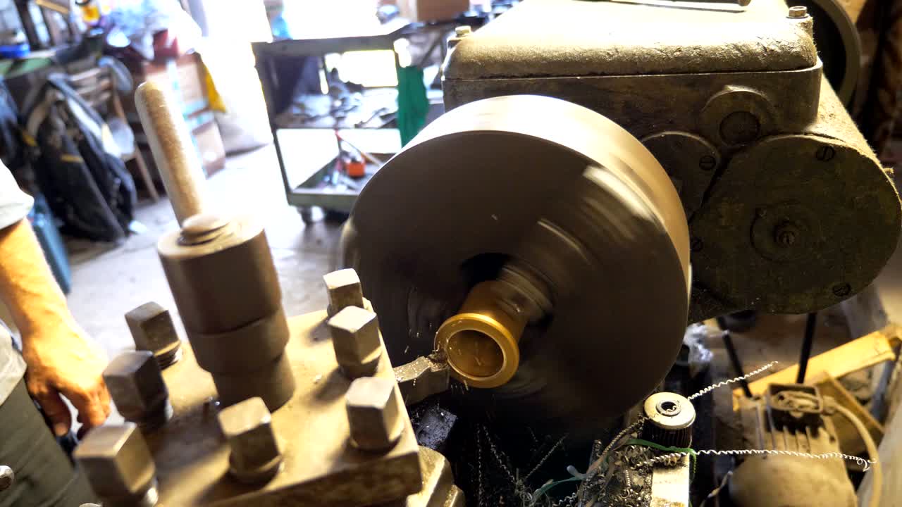 작업 중인  또는 밀링 머신: 차고 또는 워크에서 오래된 작업 벤치와 함께 일하는 인식 할 수없는 터너; 금속 가공을 위해 도자기를 사용하는 메카닉; 느린 동작.