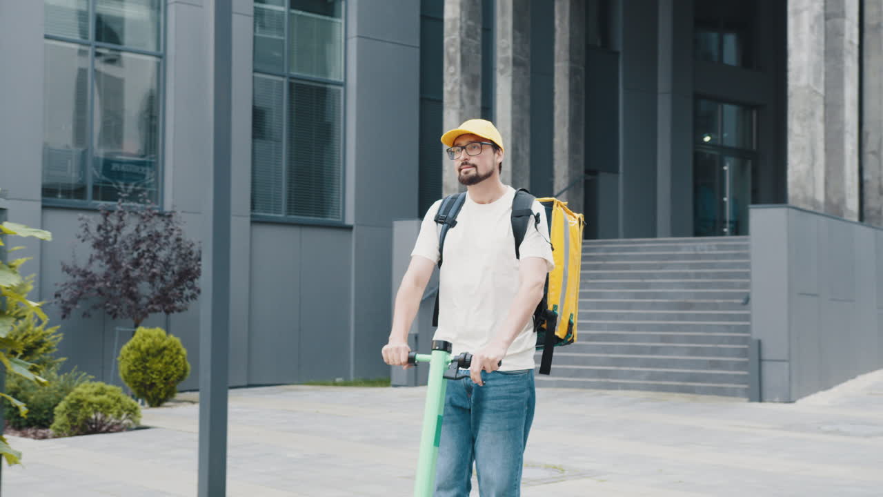 전기 스쿠터를 타고 배달하는 사람