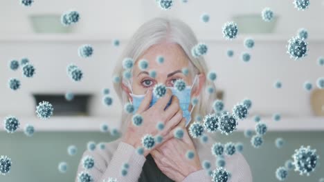 animation of covid 19 cells over woman wearing face mask