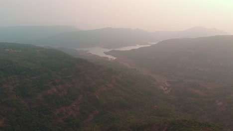 drone shot flying towards a drying reservoir