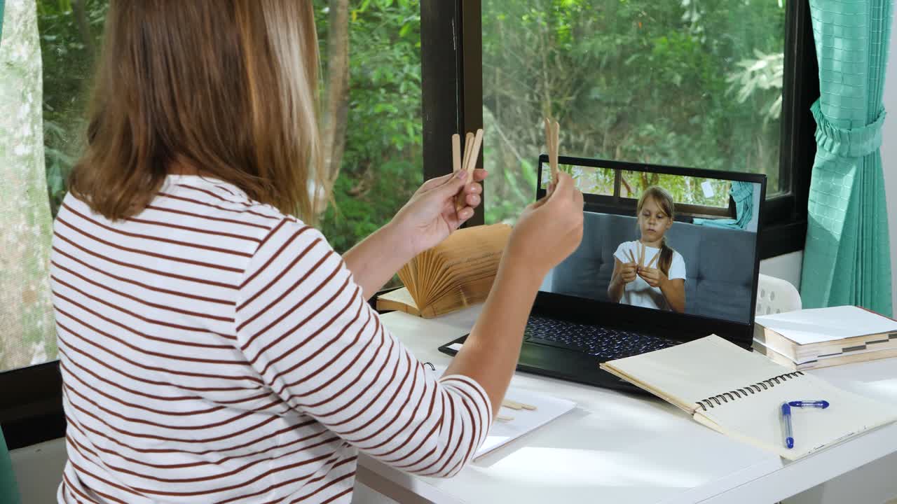 Little School Girl Has Distance Education Lesson with Teacher