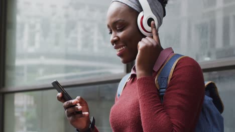 african american using her smartphone in street