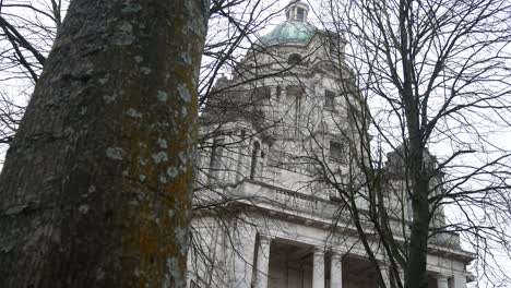 looking up at wealthy historic ashton memorial landmark historical estate building dolly right behind tree