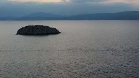 A-small-island-in-front-of-Vlychos-Plakes-Beach-in-Hydra-Island,-Greece