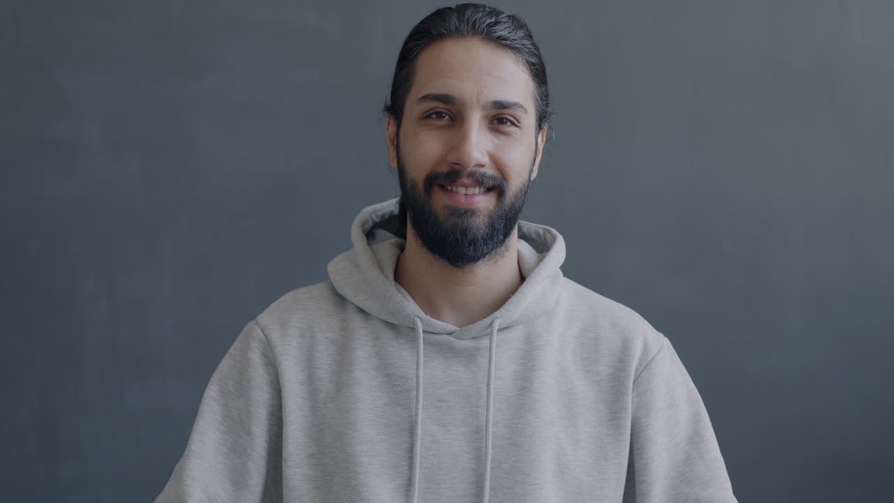 Man in a hoodie waving