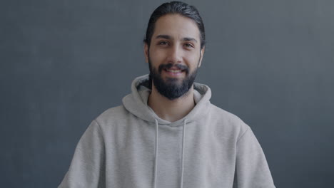 man in a hoodie waving