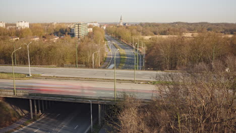 fast-moving highway traffic with natural autumn colors and suburban background