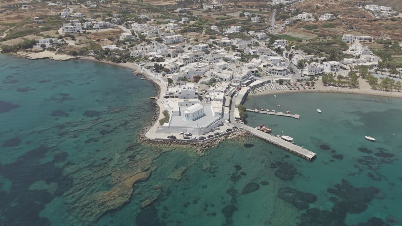 Wide aerial video of a white church in Pollonia, Milos, Greece. 3x telephoto lens. D-Log M profile. professional footage