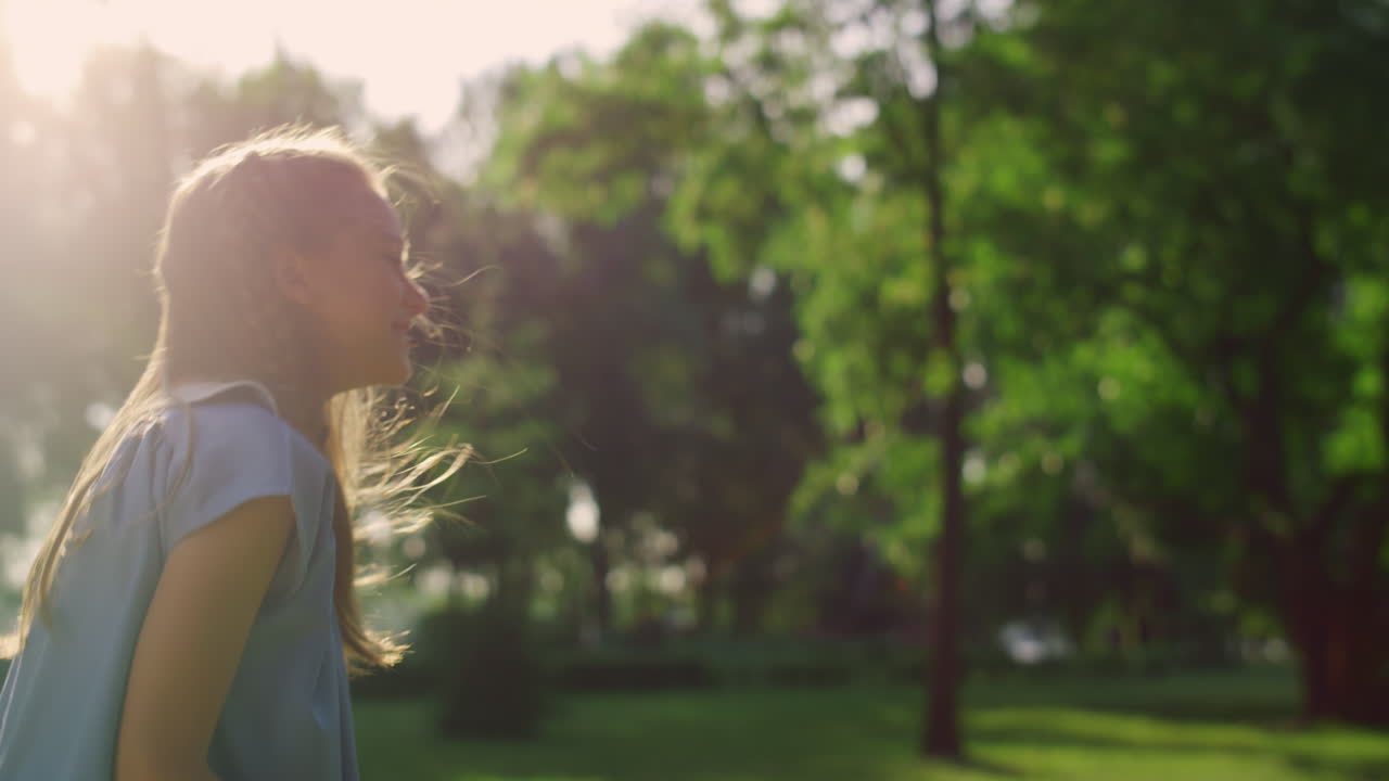 chica linda recogiendo golpeó la lanzadera con raqueta en la luz dorada del sol. fin de semana en familia