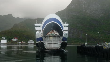 car ferry opening its front bow door in the lofoten islands on a cloudy summer day, moskenes, norway