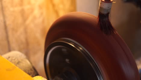 carpenter paints wooden plate by brush.