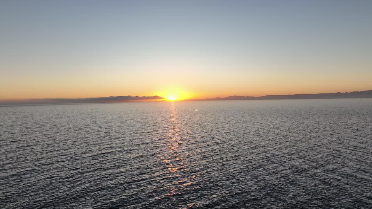 Aerial drone shot watching the sunset sun get covered by the clouds