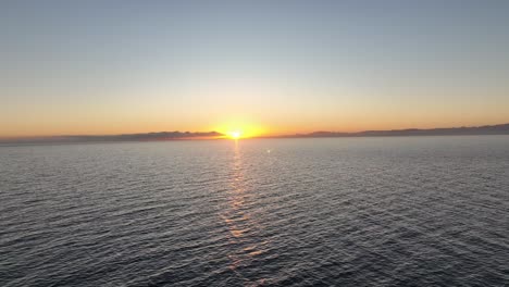 aerial drone shot watching the sunset sun get covered by the clouds