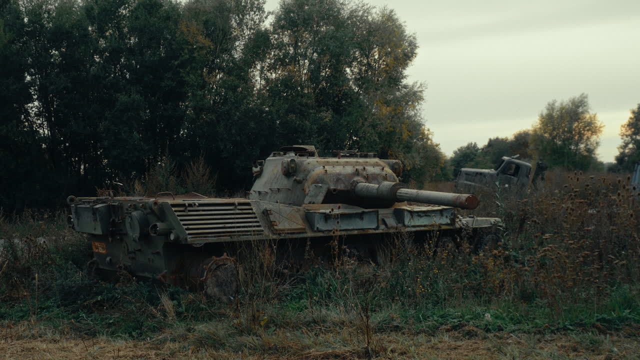 Abandoned Rusty Military Tank in Overgrown Field