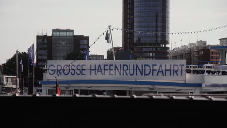 sign saying große hafenrundfahrt on tourist boat at hamburg landungsbrücken