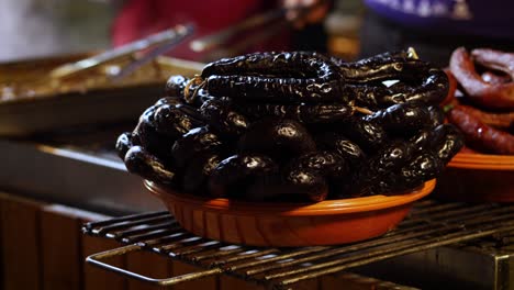street food. portuguese traditional spicy sausage being barbecued