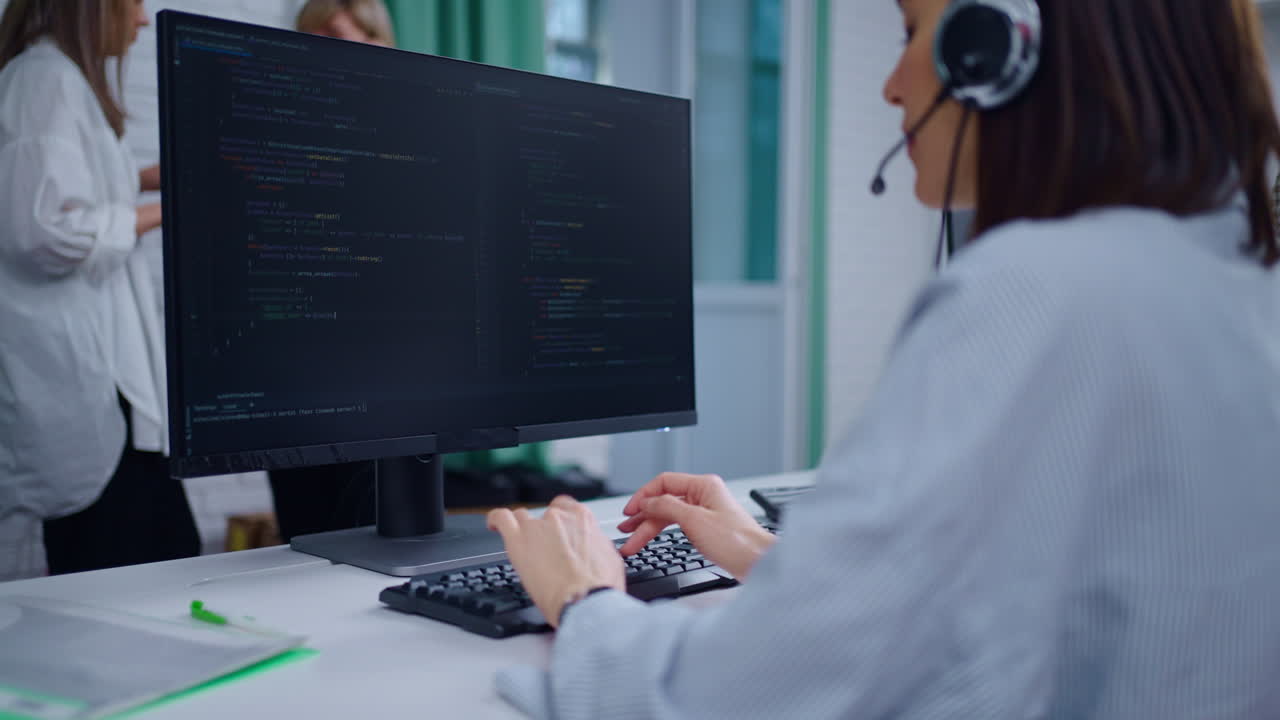 Woman programmer working on computer in office