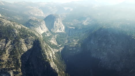 aerial shot of natural wilderness landscape surrounding yosemite falls, cascading waterfall