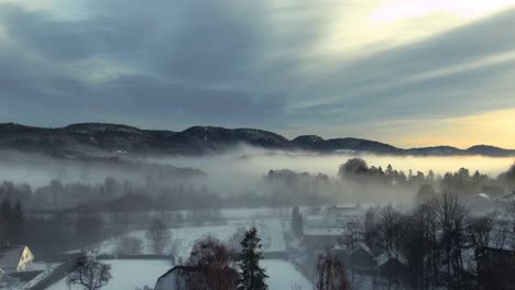 aerial drone footage of a foggy neighborhood in the winter