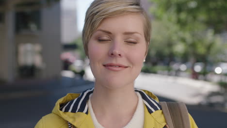 portrait-of-beautiful-blonde-woman-smiling-thoughtful-in-urban-background-wearing-yellow-jacket