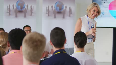 -Female-speaker-addressing-the-audience-at-a-business-conference