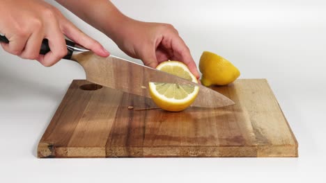 sequential lemon slicing on a wooden board