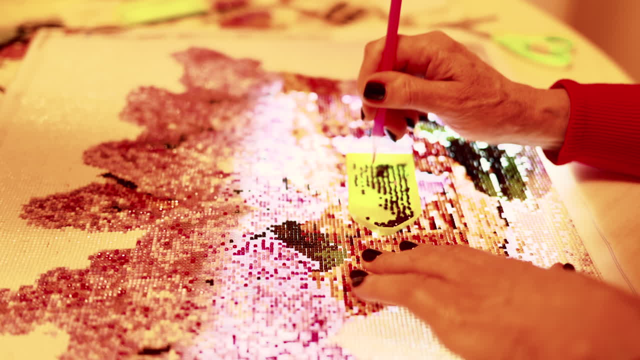 Woman making a diamond mosaic painting