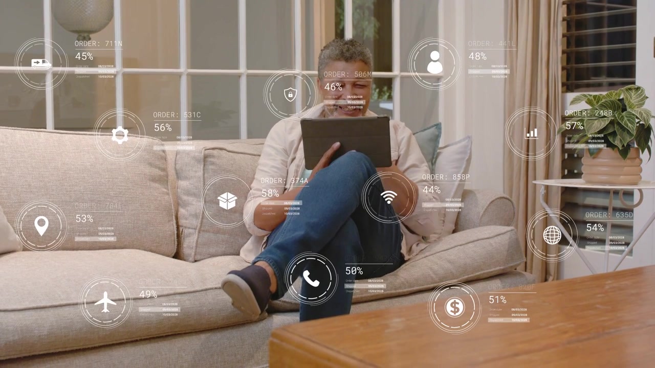 Vertical video: Mature man tapping tablet on sofa, initiating AR icons and charts tracking finances